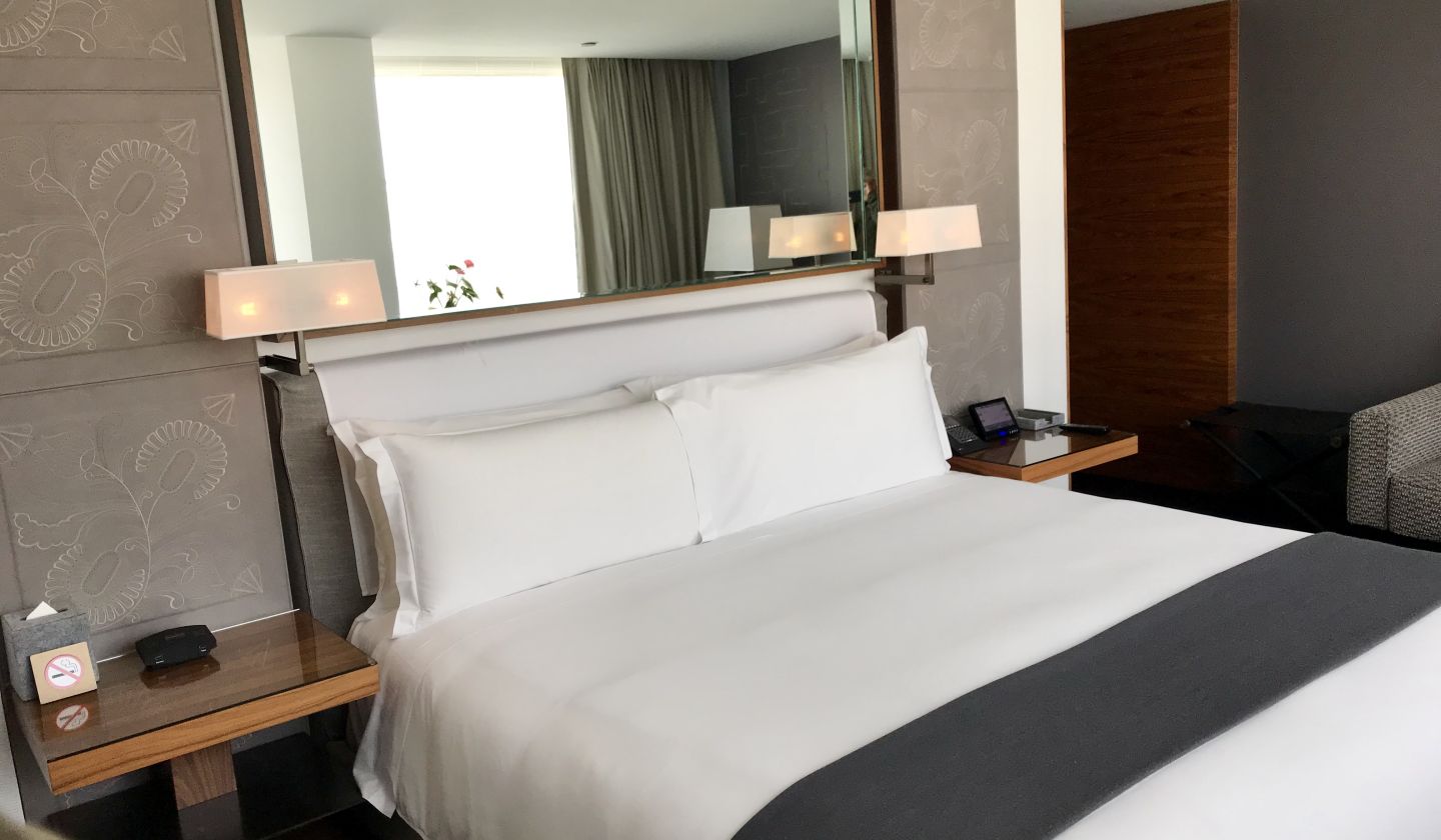 A Bedroom With A Large Bed In A Hotel Room